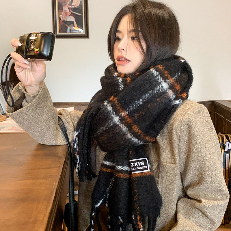 woman wearing oversized beige plaid winter scarf thick cozy fleece wrap