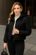 woman wearing a black winter puffer jacket with fur trim